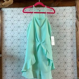 Teal colored jumper with zip up back